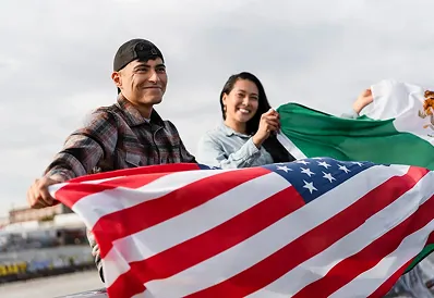 An immigrant family holding the American flag, the community Rapido Refunds serves