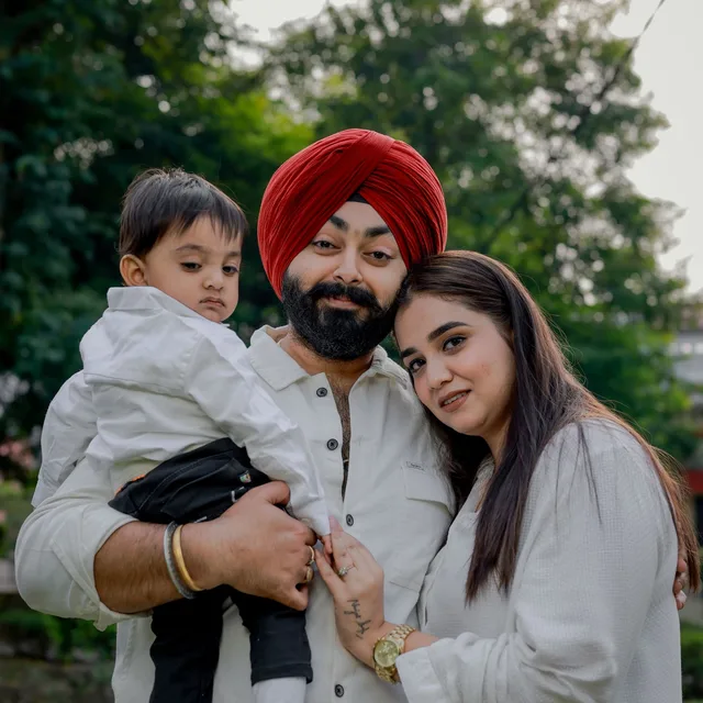 A South Asian couple holding their toddler, part of the Queens community Rapido Refunds serves