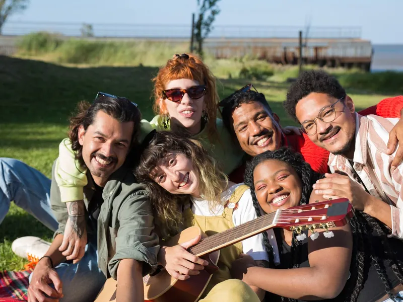 A group of friends and neighbors laughing together outdoors