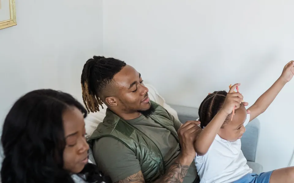 A family relaxing together on the couch at home